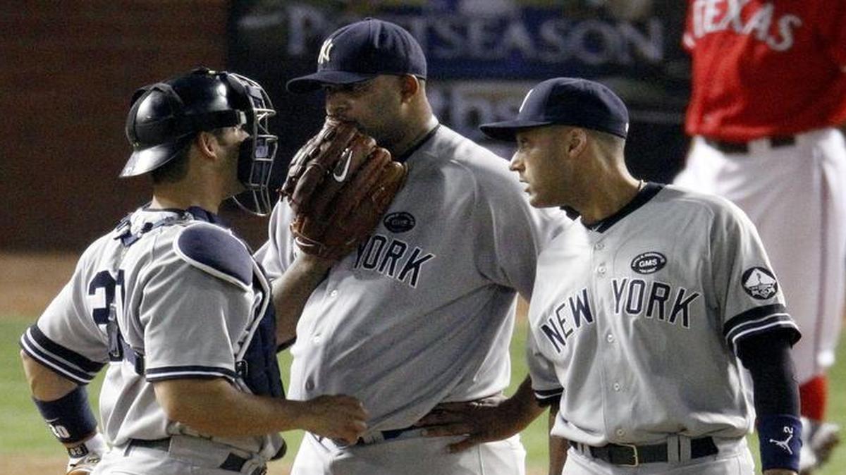 From left, Yankees catcher Jorge Posada, pitcher CC Sabathia and shortstop Derek Jeter talk strategy during a 2010 playoff game against the Rangers in Texas. The origin of talking into gloves on the mound is unclear, but some say it followed a grand slam given up by Greg Maddux in 1989.