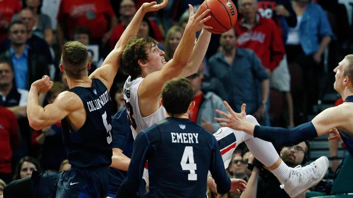 Gonzaga forward Kyle Wiltjer, in white, grabs a rebound over BYU guard Kyle Collinsworth, left, BYU forward Nate Austin, right, and BYU guard Nick Emery (4) during the second half of a West Coast Conference tournament semifinal Monday in Las Vegas. Gonzaga won 88-84.