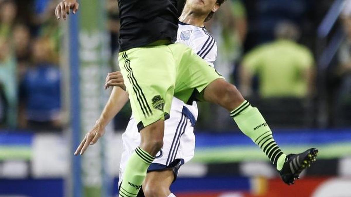 Sounders midfielder Lamar Neagle wins a header over Whitecaps defender Diego Rodriguez during the second half of a CONCACAF Champions League soccer match Sept. 23 in Seattle. Neagle, a Federal Way native, is to be traded to D.C. United.
